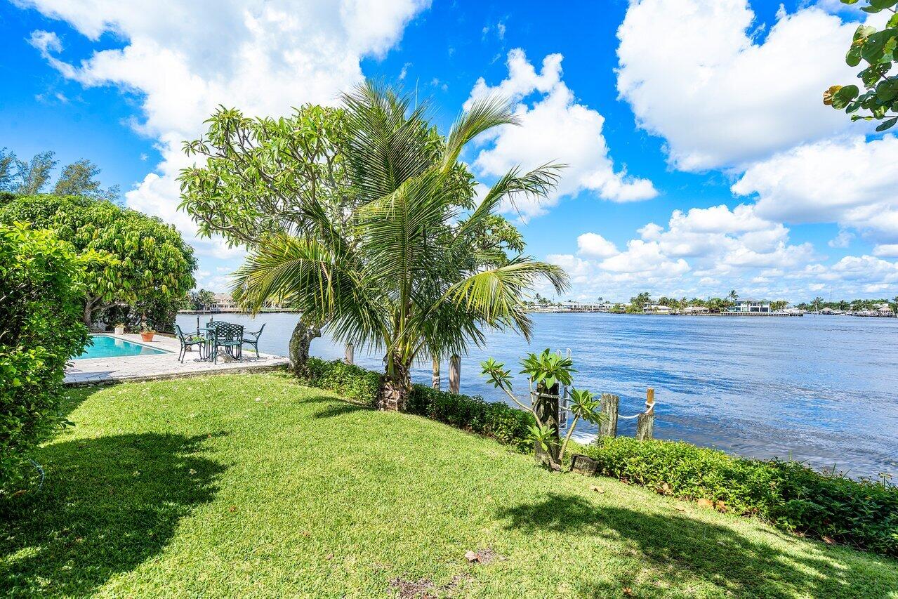 7 Sabal Island Drive Ocean Ridge, FL 33435 - Photo 3 of 44 a front view of a house with garden