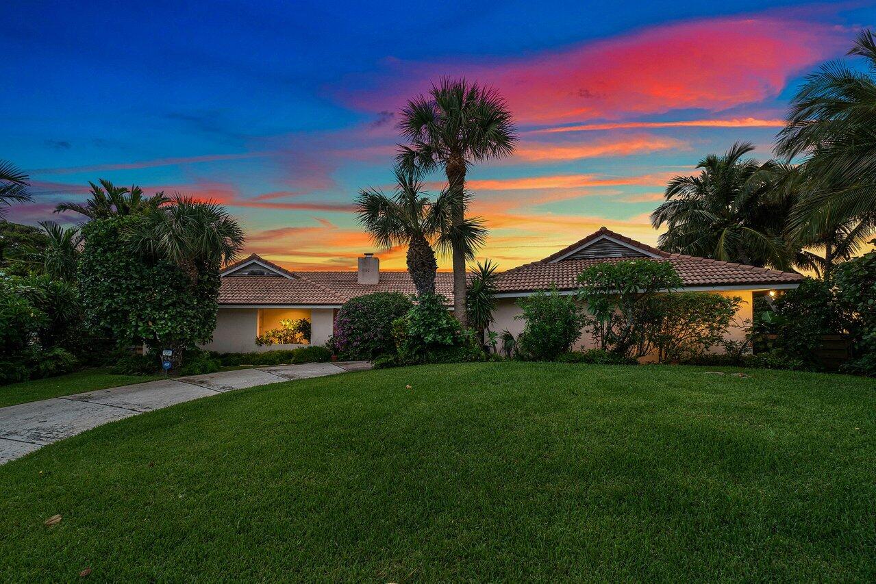 7 Sabal Island Drive Ocean Ridge, FL 33435 - Photo 32 of 44 a front view of a house with a garden and yard
