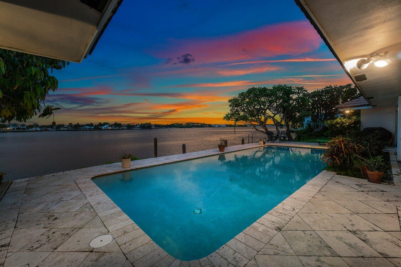 7 Sabal Island Drive Ocean Ridge, FL 33435 - Photo 38 of 44 a view of a swimming pool and an outdoor seating