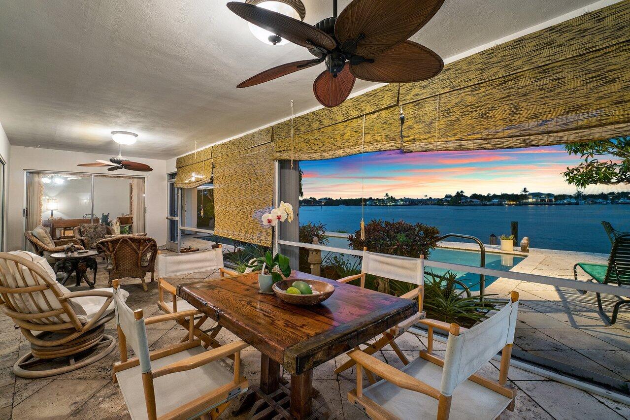 7 Sabal Island Drive Ocean Ridge, FL 33435 - Photo 39 of 44 a view of a patio with a dining table and chairs