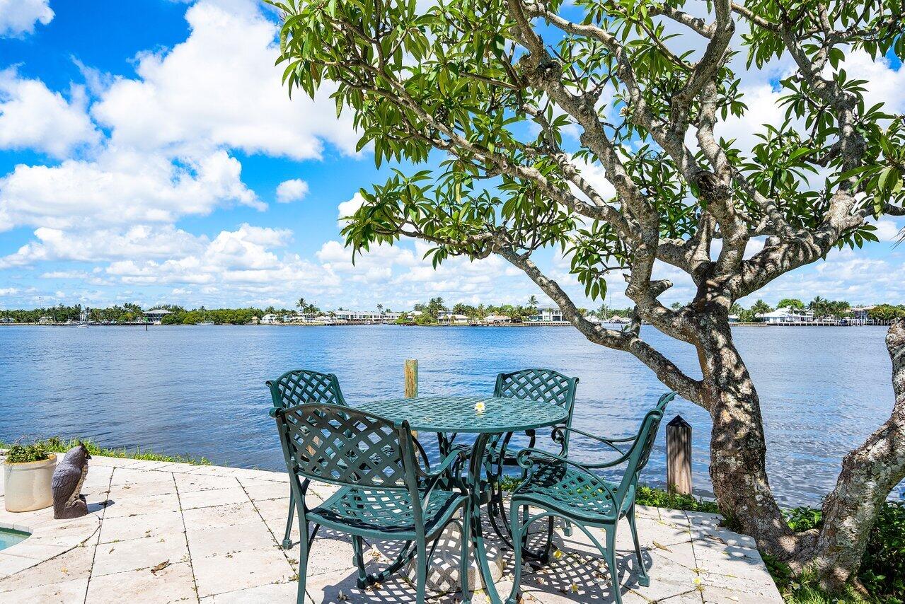 7 Sabal Island Drive Ocean Ridge, FL 33435 - Photo 6 of 44 a view of a lake with table and chairs