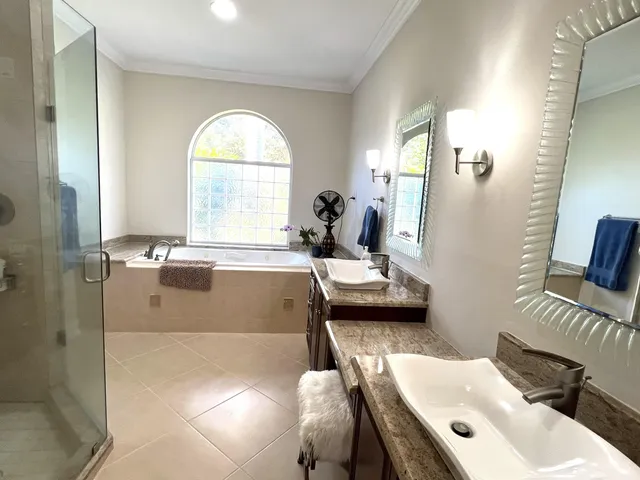 a bathroom with a tub sink and mirror