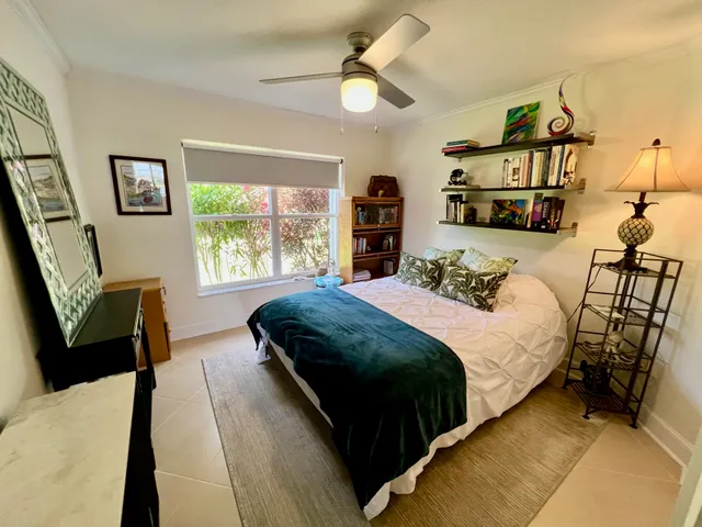 a bedroom with a bed couch and a window