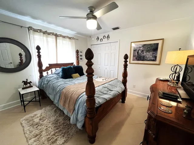 a bed room with a bed and a chair