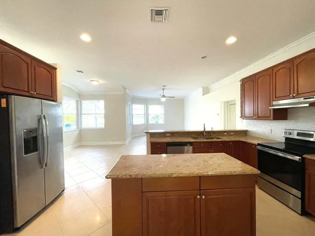 a kitchen with a stove a refrigerator and a sink