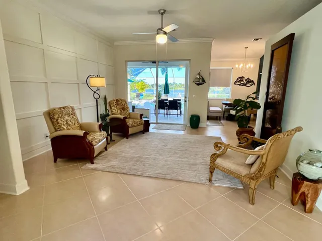 a living room with furniture and a chandelier