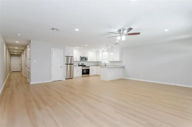 a view of a kitchen with a sink and a refrigerator