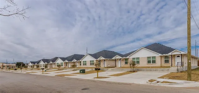 an aerial view of residential houses and street