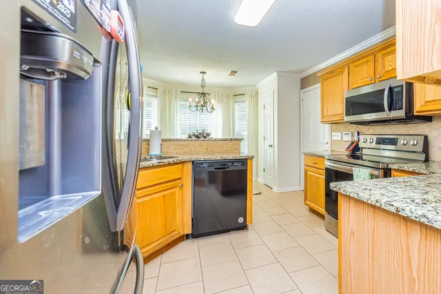 a kitchen with stainless steel appliances granite countertop a stove and a refrigerator