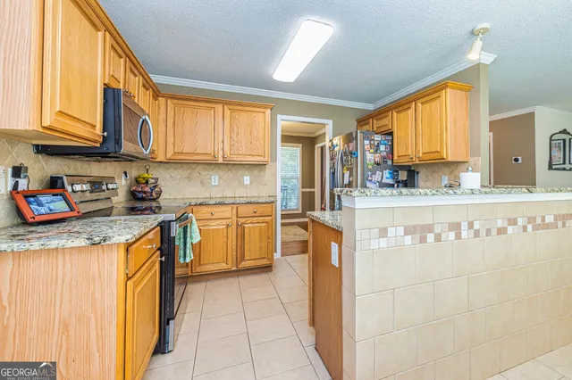 a kitchen with stainless steel appliances granite countertop a sink and cabinets