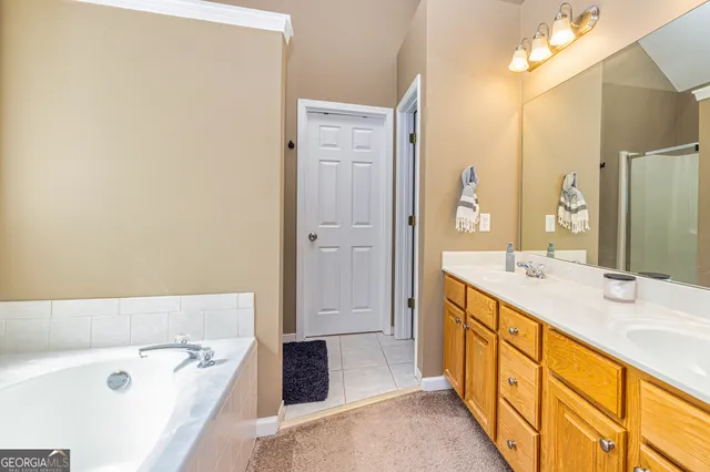 a bathroom with a tub sink and mirror