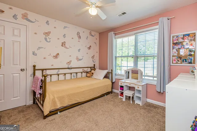 a bed sitting in a bedroom next to a window