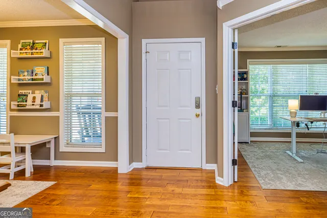 a view of a livingroom with wooden floor and furniture