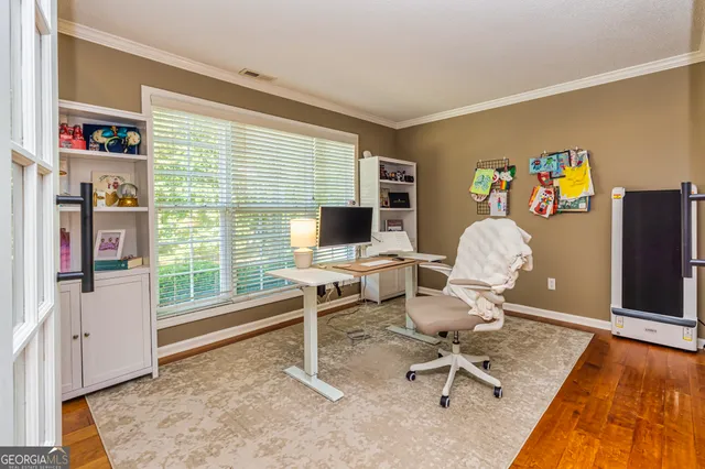 a work room with furniture and a flat screen tv