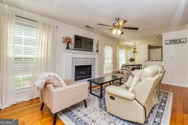 a living room with furniture a fireplace and a flat screen tv