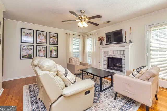 a living room with furniture fireplace and window