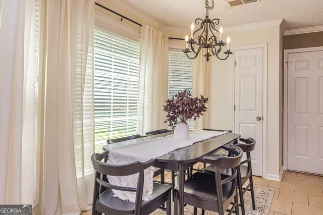a view of a dining room with furniture and chandelier