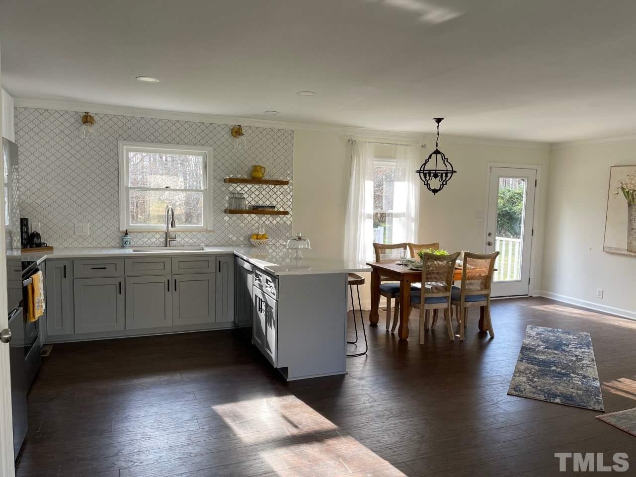 7009 Kiger Road Rougemont, NC 27572 - Photo 11 of 25 a kitchen with a table chairs and a window