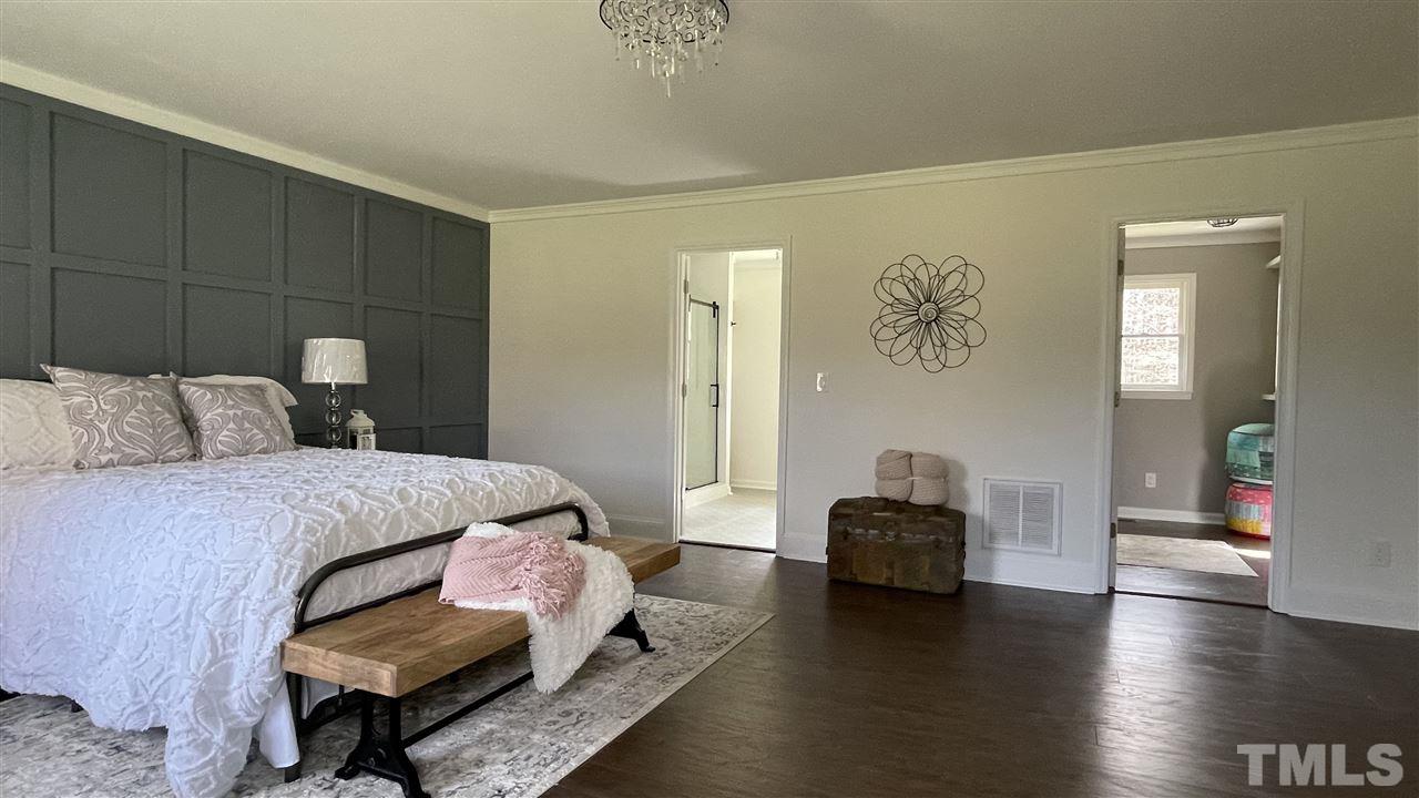 7009 Kiger Road Rougemont, NC 27572 - Photo 19 of 25 a bedroom with a bed and wooden floor