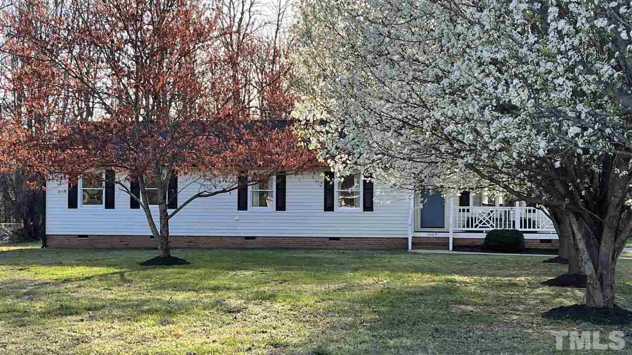 7009 Kiger Road Rougemont, NC 27572 - Photo 3 of 25 a house that has a tree in front of a house