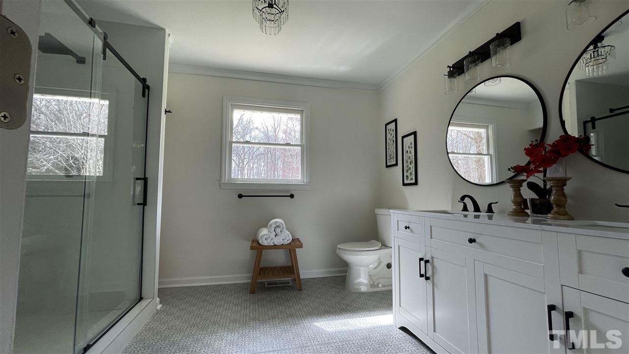 7009 Kiger Road Rougemont, NC 27572 - Photo 21 of 25 a bathroom with a toilet sink and mirror