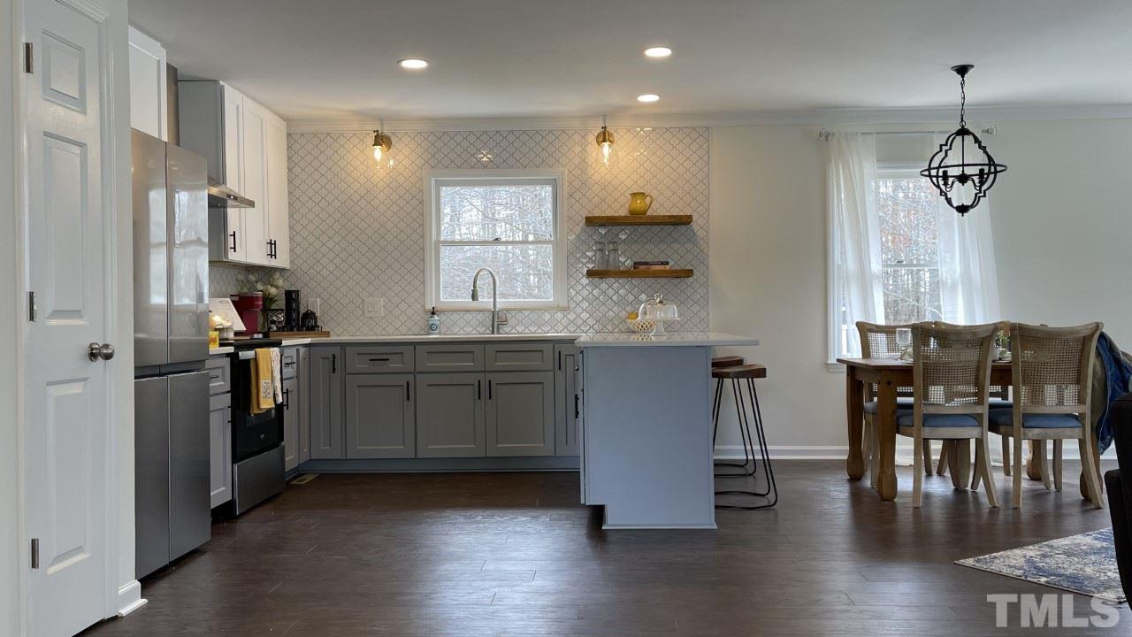 7009 Kiger Road Rougemont, NC 27572 - Photo 8 of 25 a kitchen with a table chairs refrigerator and cabinets