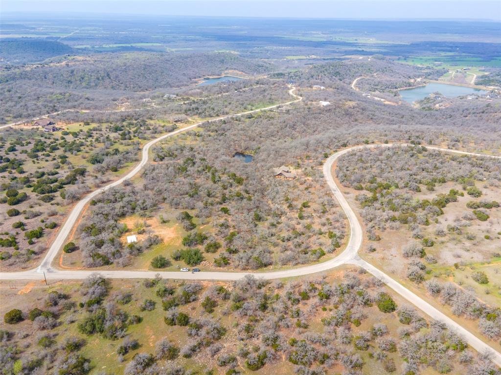 E49 R Art's Way Gordon, TX 76453 - Photo 19 of 26 Expansive rural landscape featuring winding paved roads, varied terrain, and multiple water features