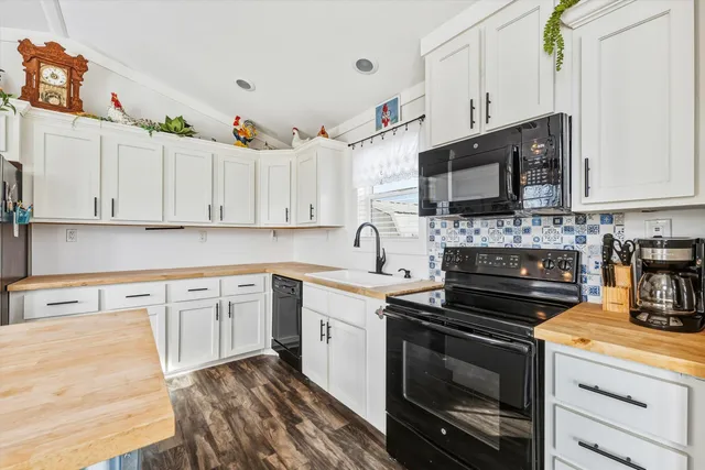 a kitchen with cabinets stainless steel appliances and a counter space
