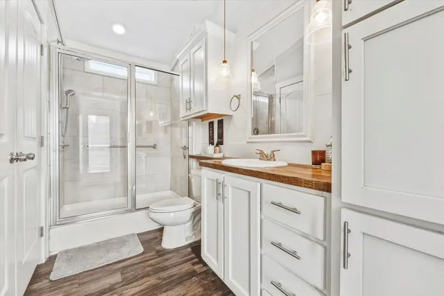 a bathroom with a double vanity sink toilet and shower