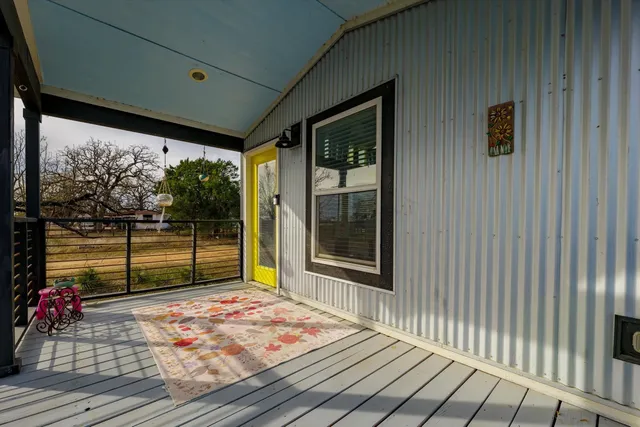 a view of a balcony with wooden floor