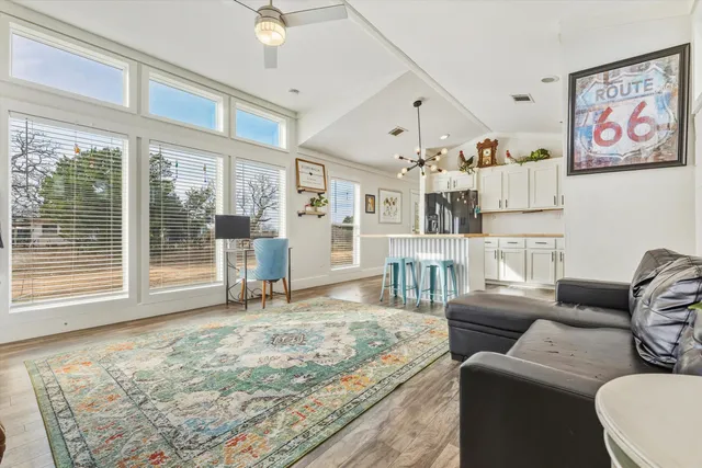 a living room with furniture and large window