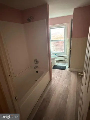 a bathroom with a tub a sink and a shower