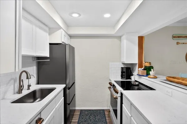 a kitchen that has a sink and a stove