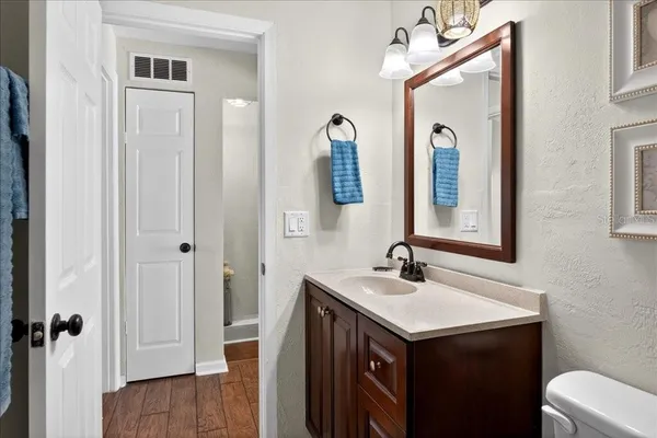 a bathroom with a sink vanity and a mirror