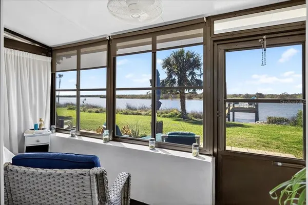 a room with furniture and large windows
