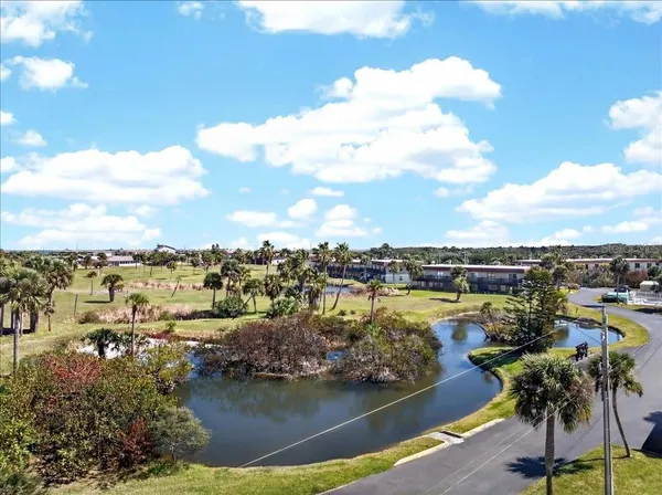 a view of a terrace with lawn chairs