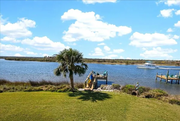 a view of a lake with houses in back