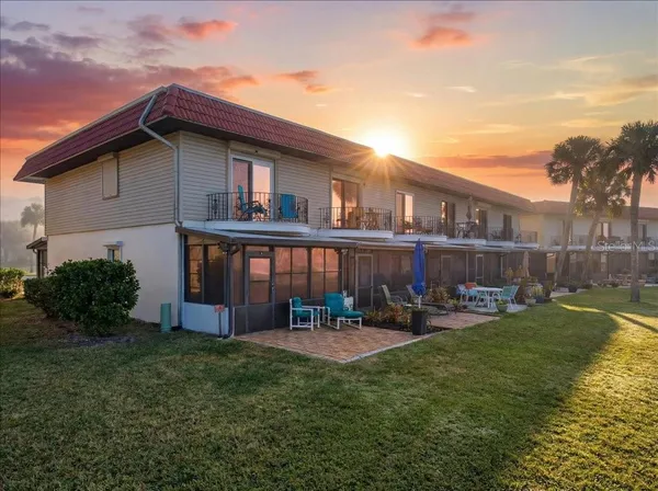 a view of a house with backyard porch and sitting area