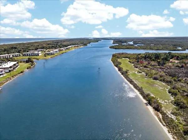 an aerial view of a house with a swimming pool and outdoor seating