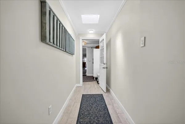 a view of a hallway with wooden floor and staircase