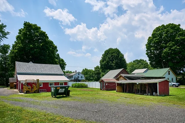 a view of a house with a yard and sitting area
