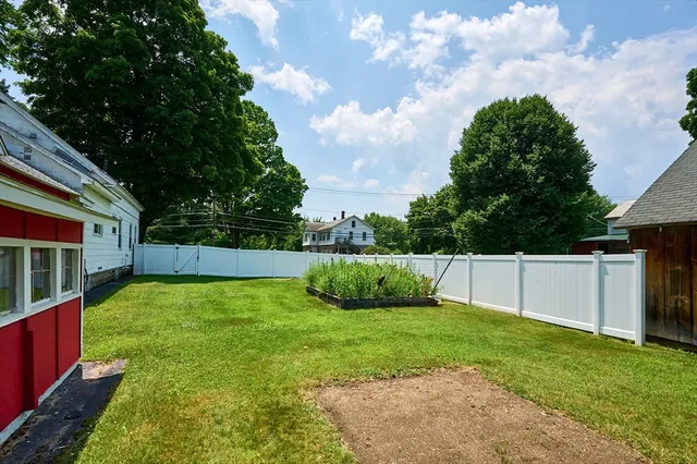 a view of backyard with swimming pool