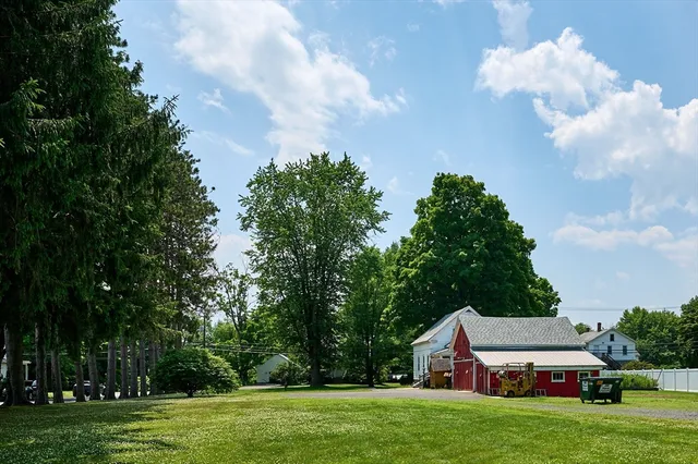 a aerial view of a house with big yard and large trees
