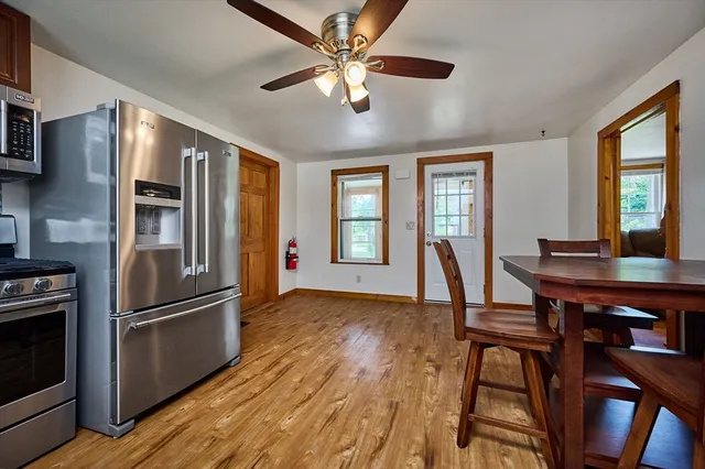 a view of a dining room with furniture window and wooden floor
