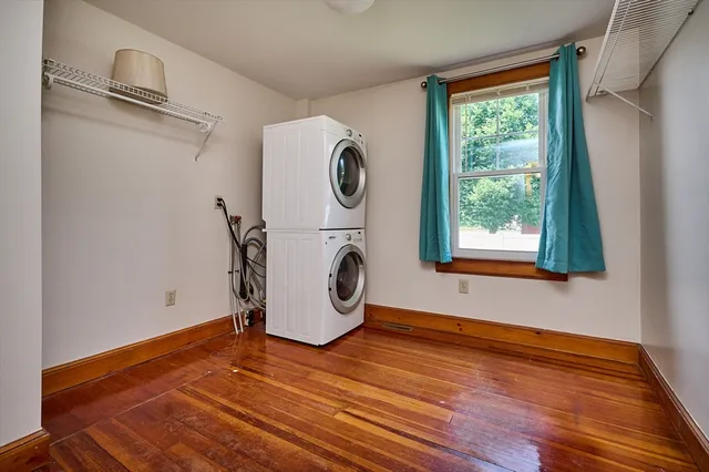 a view of a room with wooden floor and window