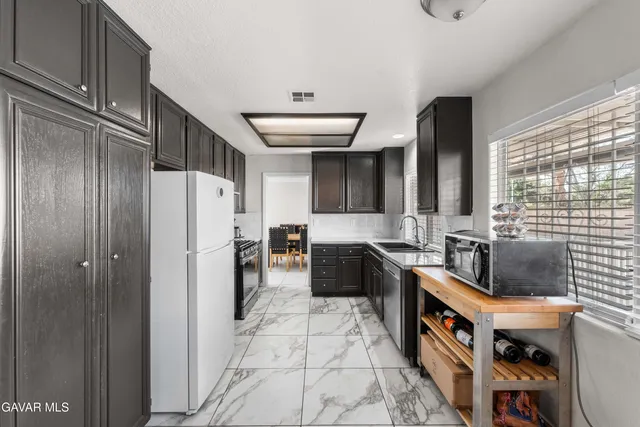 a kitchen with stainless steel appliances a refrigerator and a stove