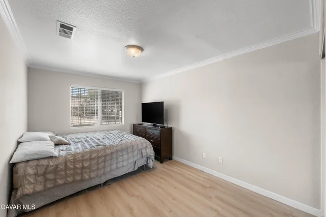 a bedroom with a bed and a television