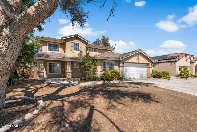 a front view of a house with yard and porch