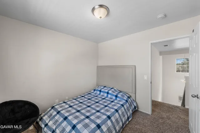 a bedroom with a bed and cabinets