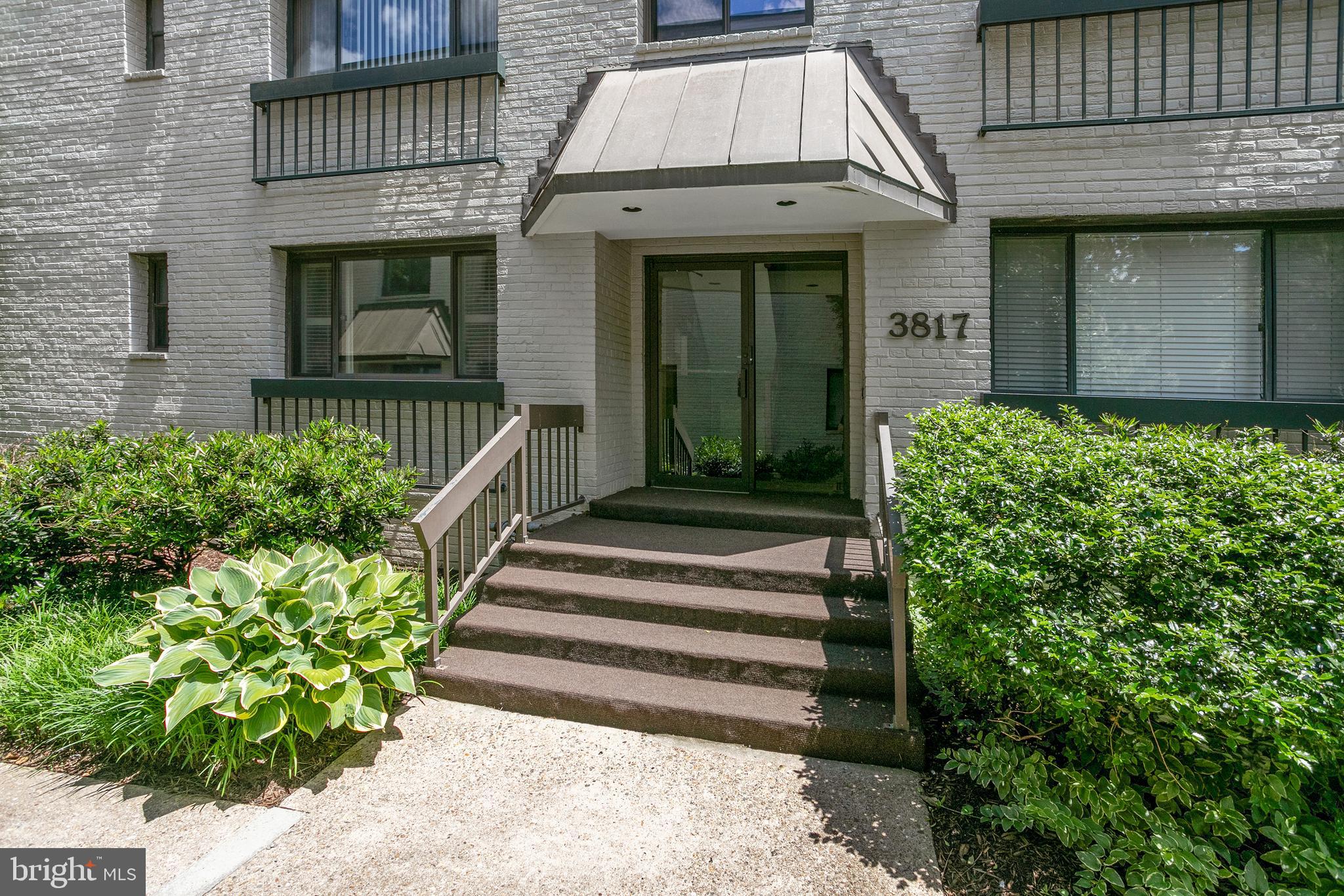 3817 Davis Place Northwest, Unit 2 Washington, DC 20007 - Photo 14 of 21 a view of a house with large windows and flower plants